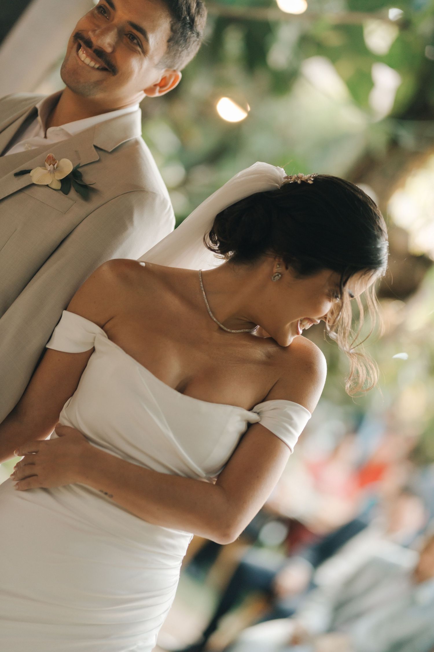 Couple sharing intimate moment during outdoor wedding ceremony.