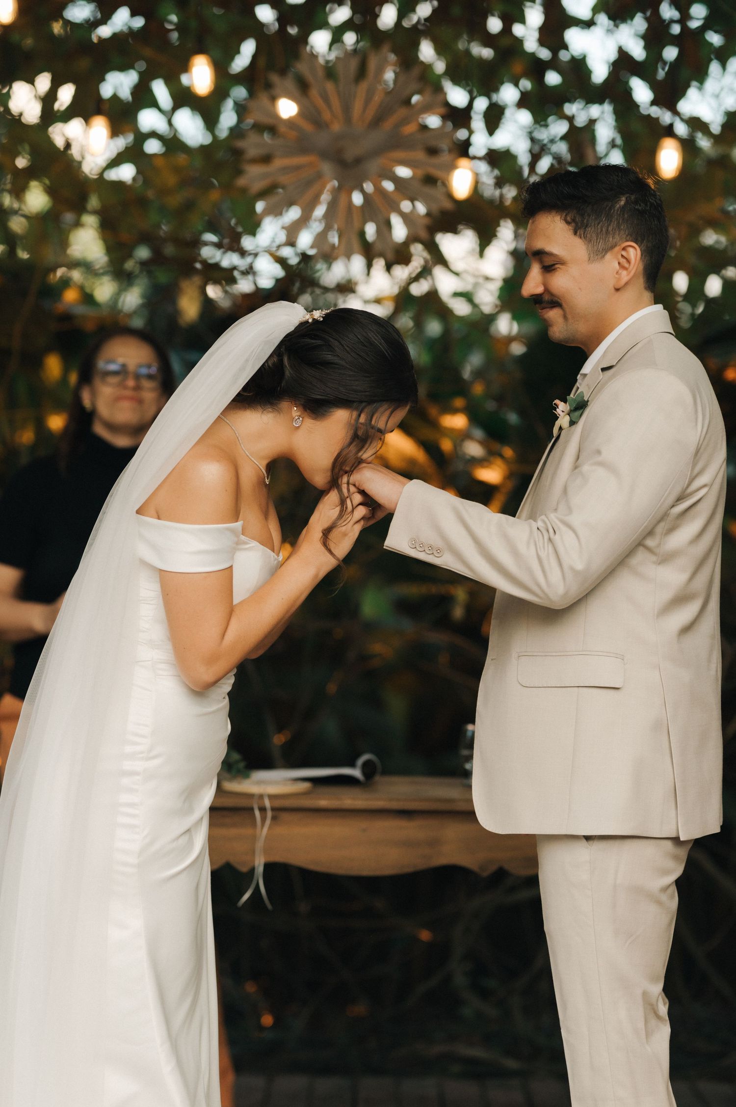 Sweet moment during a wedding ceremony as the bride kisses the groom's hand.