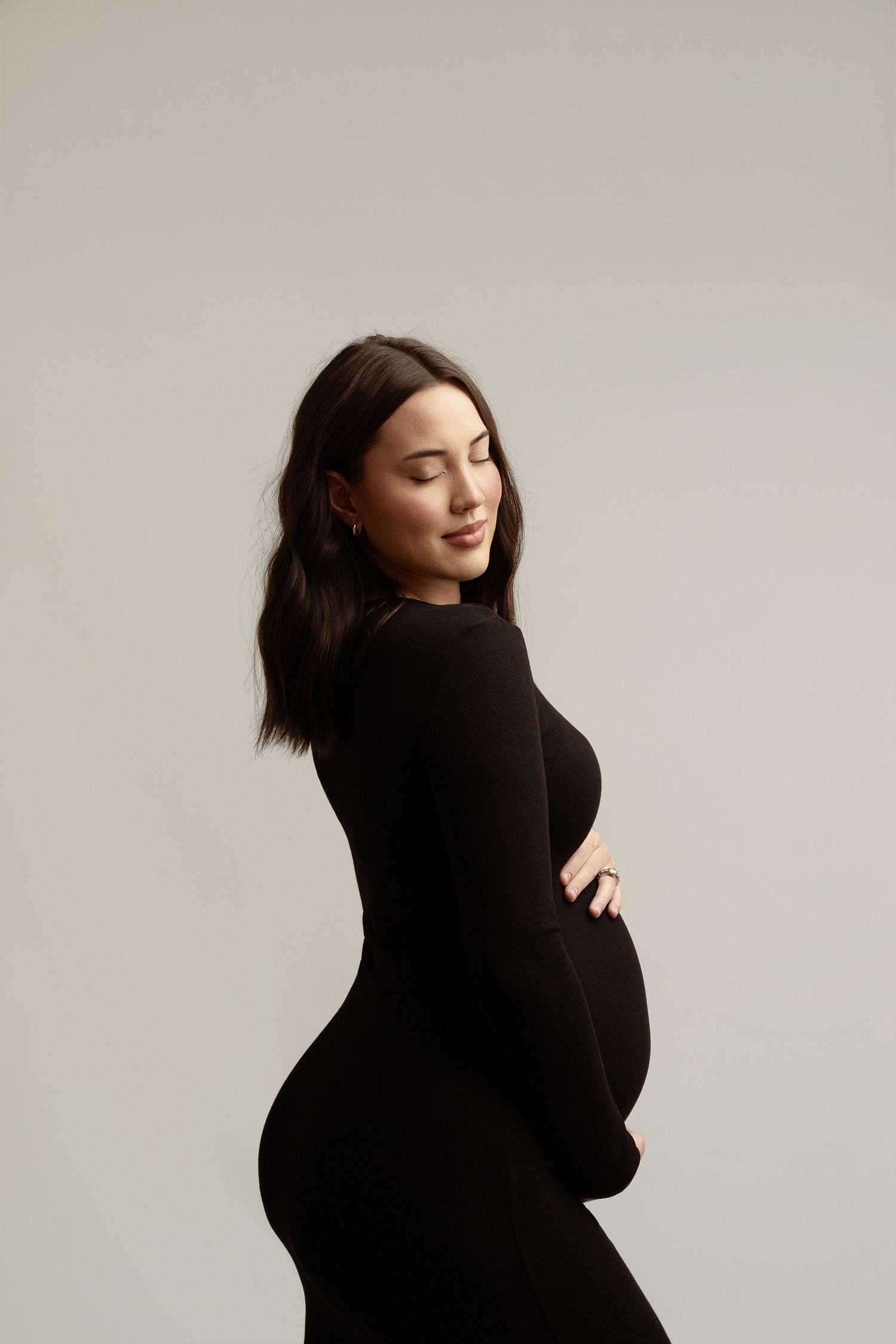 Intimate maternity boudoir photo featuring a light blue button-down shirt and natural lighting. maternity photographer Paloma Schell Houston
