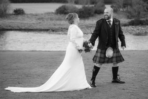 bride and groom walking along riverbank at banchory lodge hotel