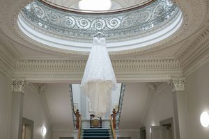 Grand interior space featuring decorative ceiling dome and classical architectural details.