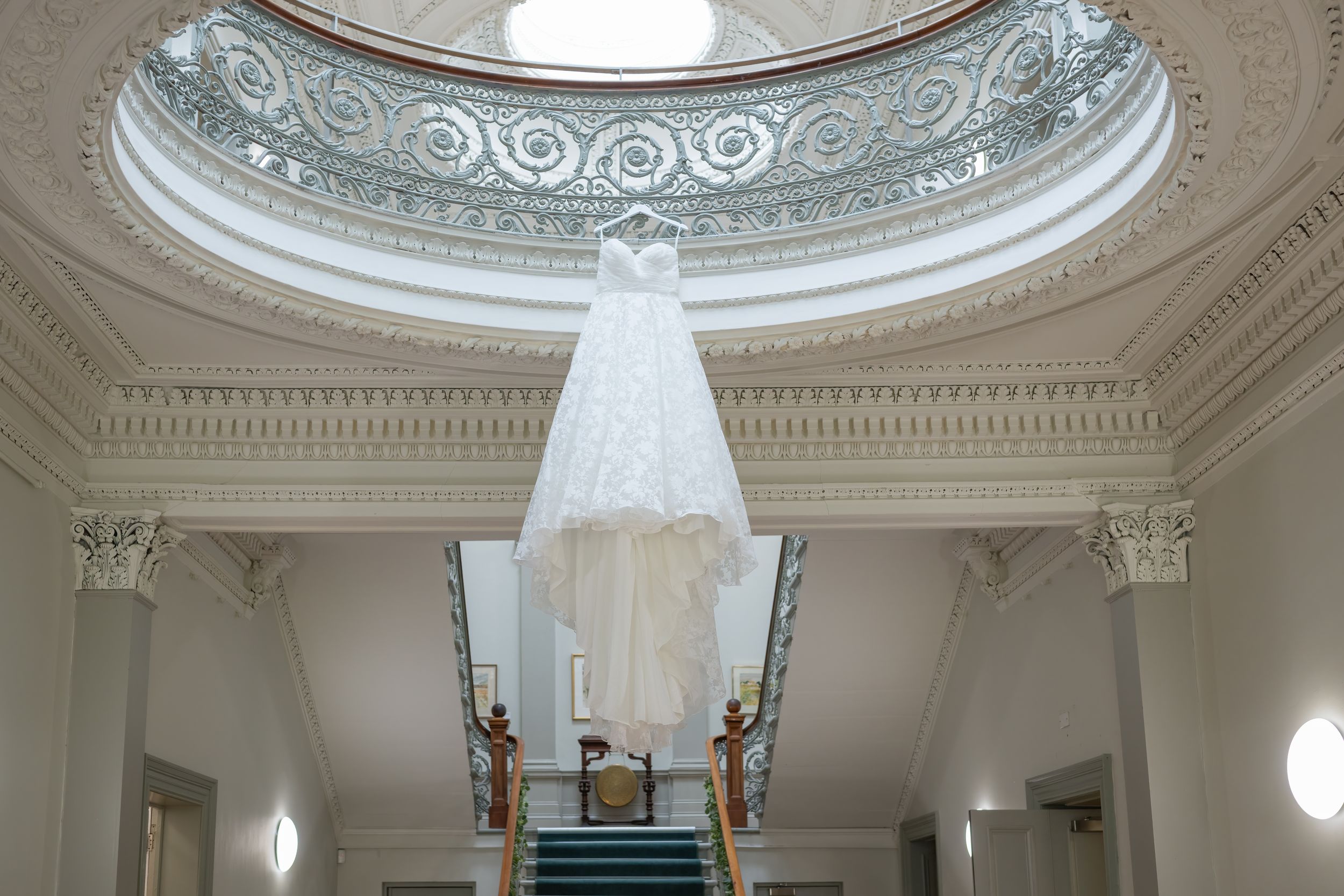 Grand interior space featuring decorative ceiling dome and classical architectural details.