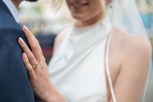 Close-up shot of wedding rings being exchanged during a ceremony.