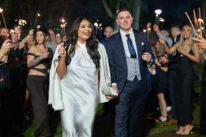 Nighttime wedding celebration with sparklers creating a magical atmosphere.