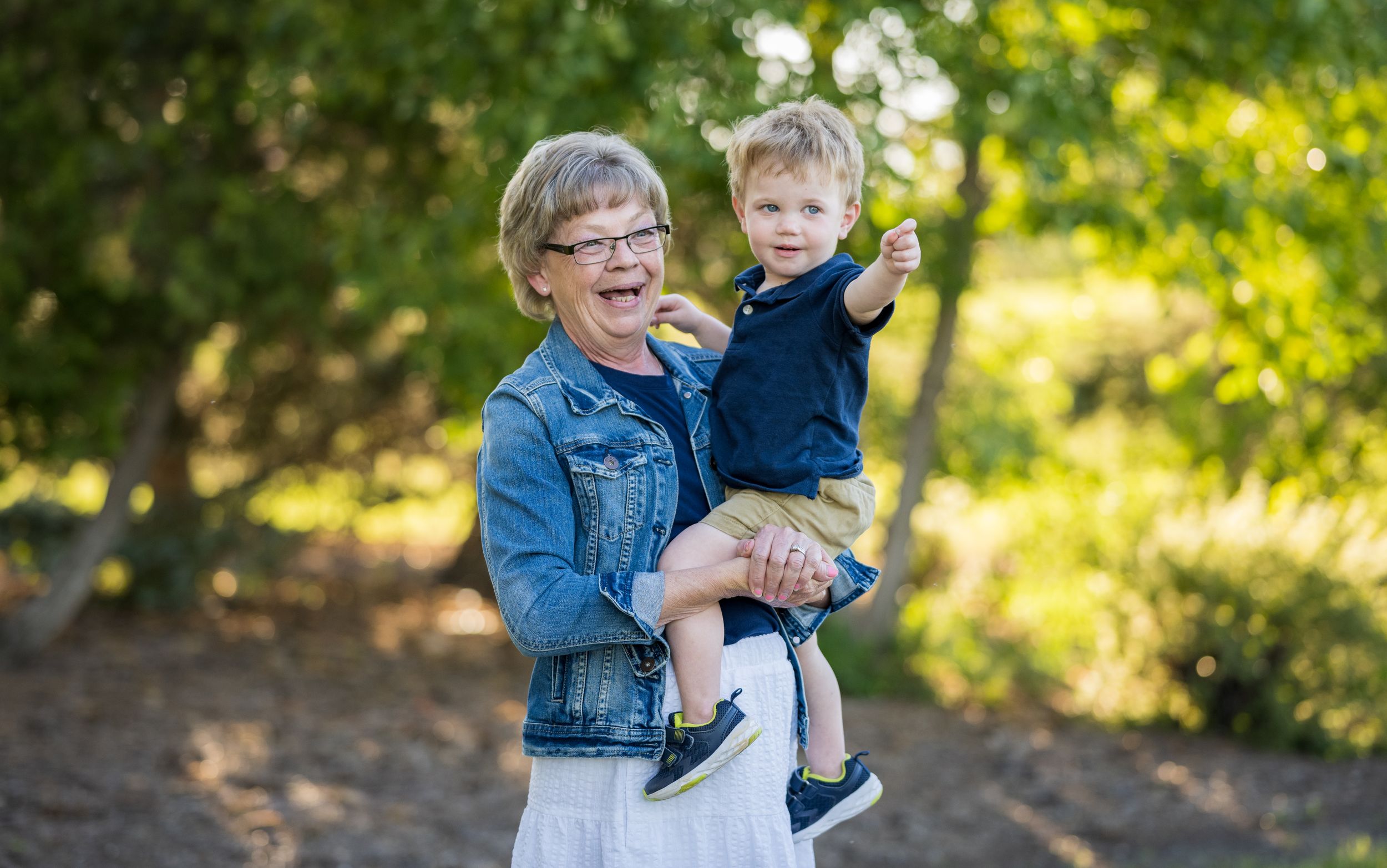 A joyful moment shared between family members in a sunny outdoor setting.