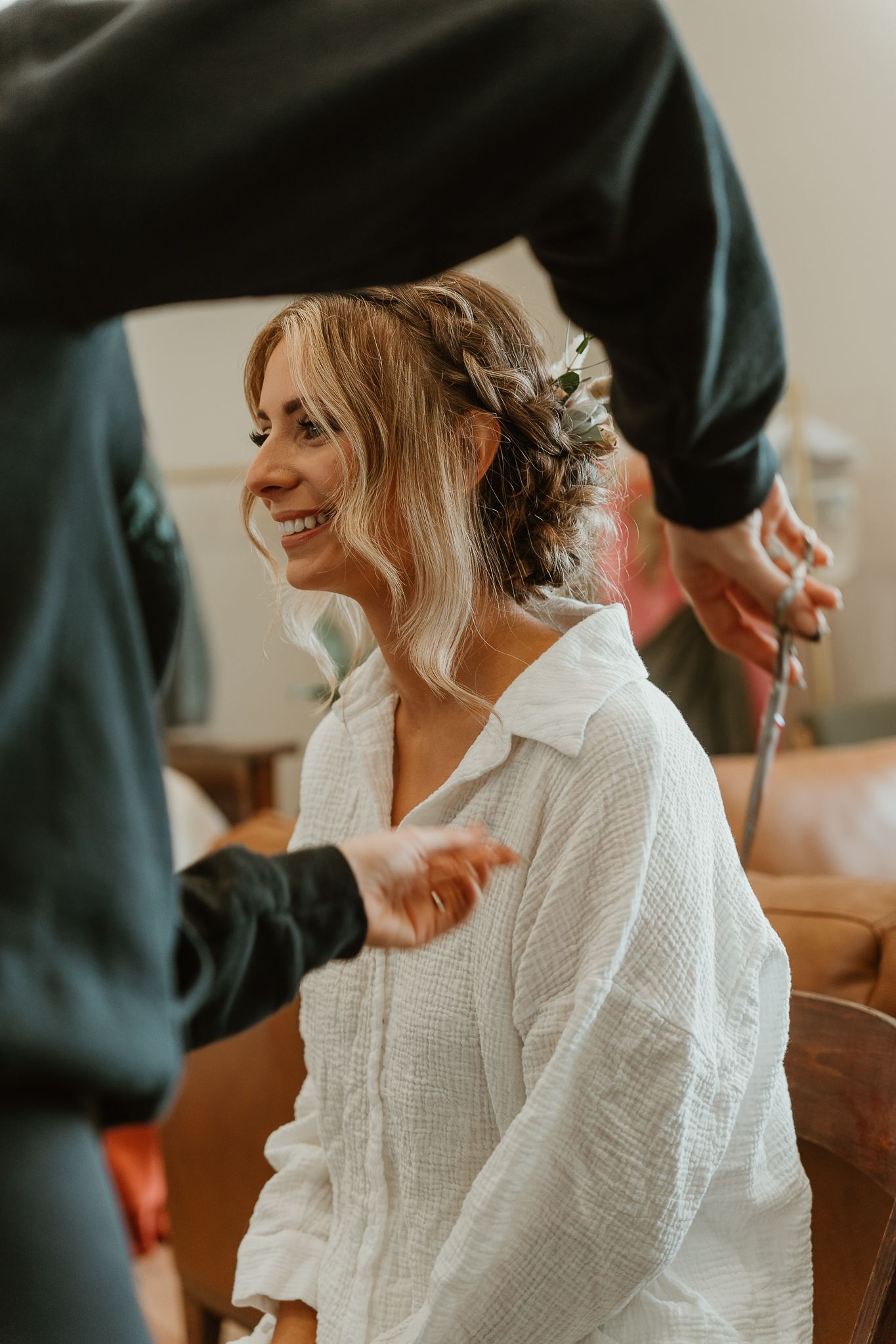 Details of the final touches being done by hairstylist.