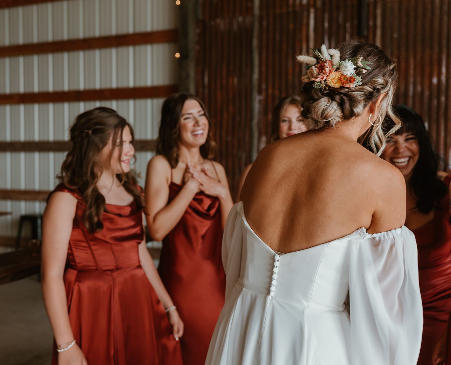 MOH shows joy seeing the bride in her wedding dress.
