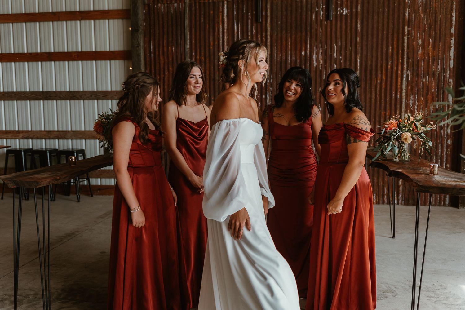 Bridesmaids oooing and awwing the bride.