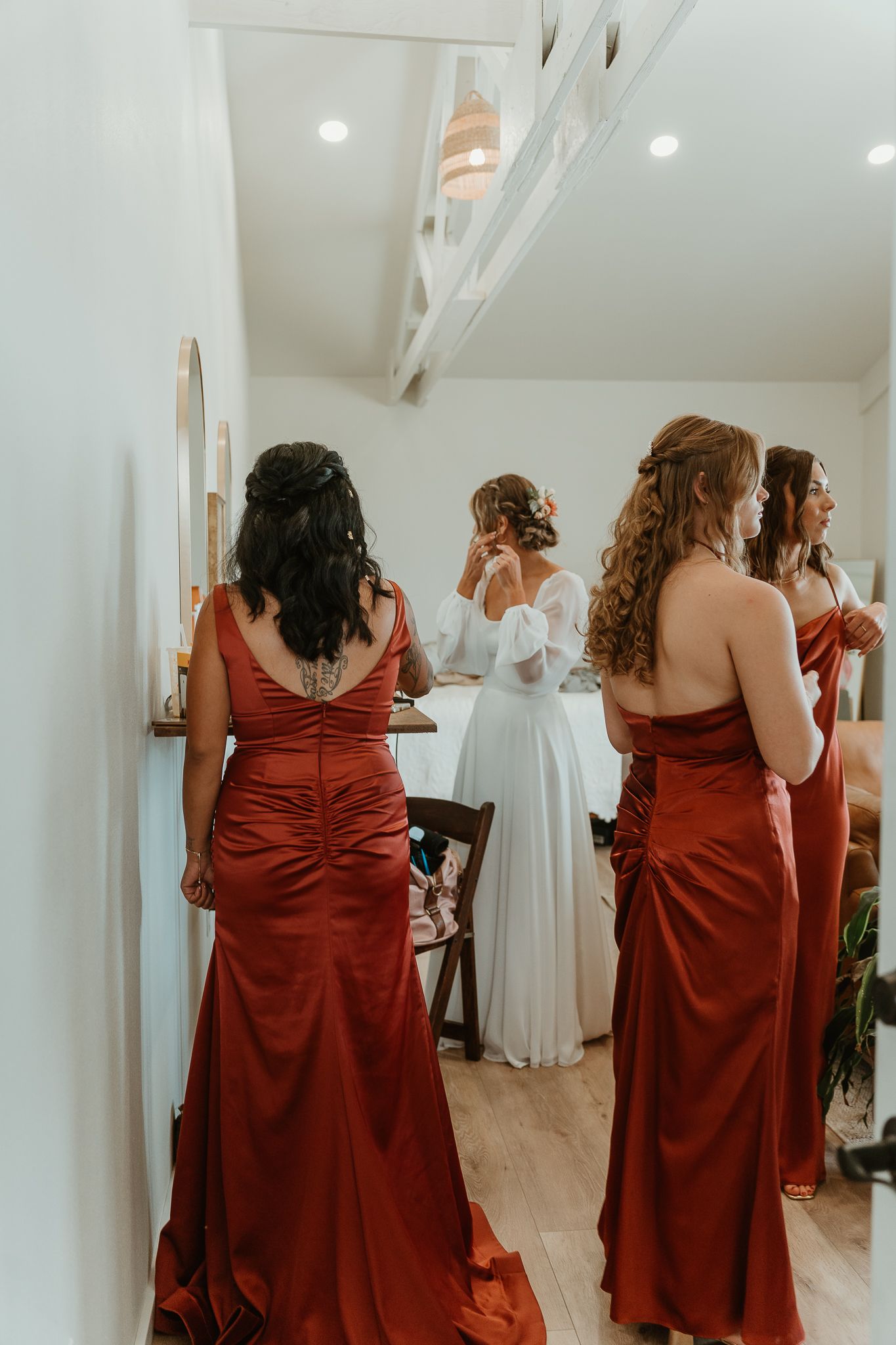 Bride and bridesmaids doing final touches before they walk down the isle.