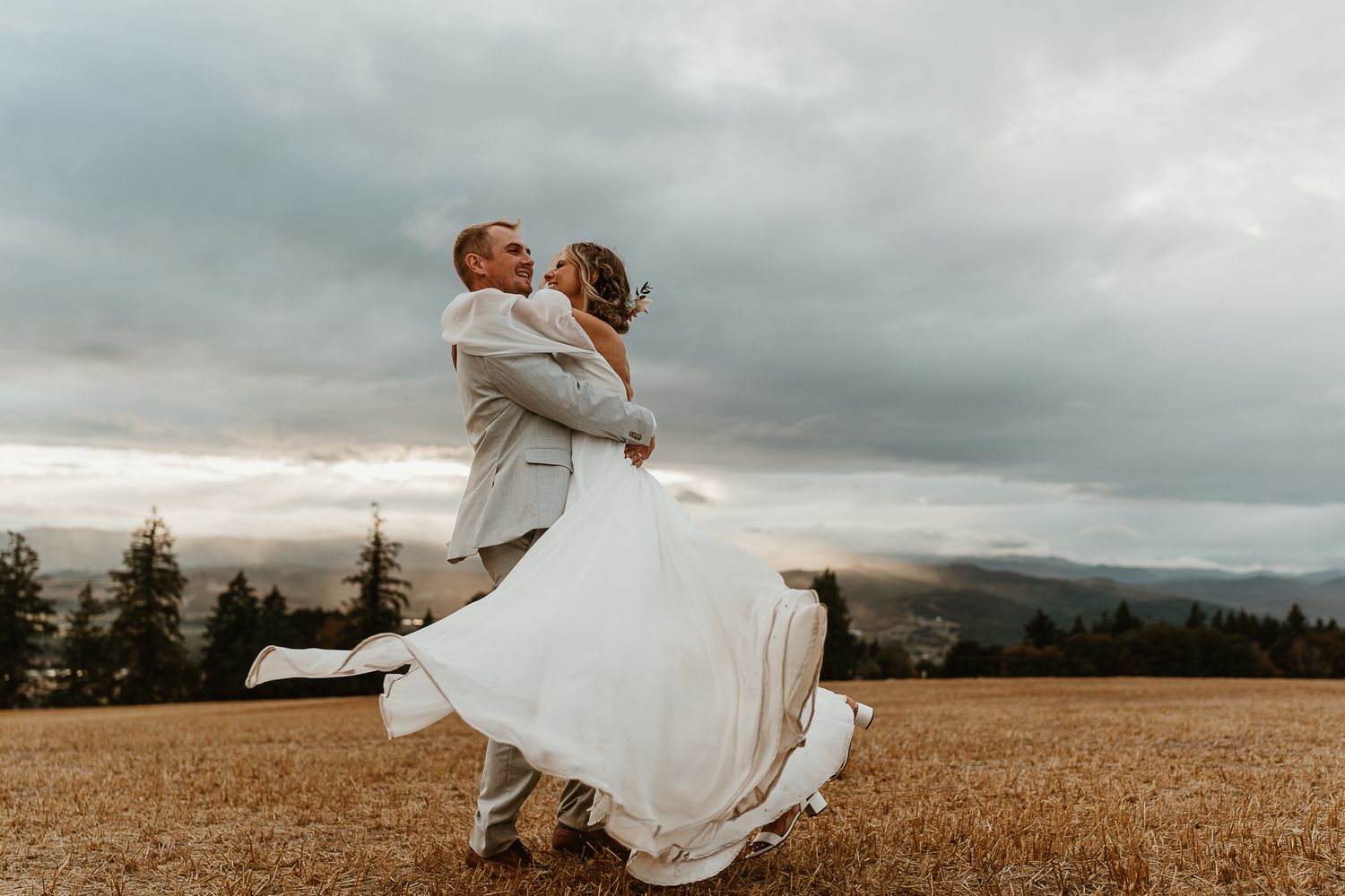 Groom spinning bride for dramatic movement photos.