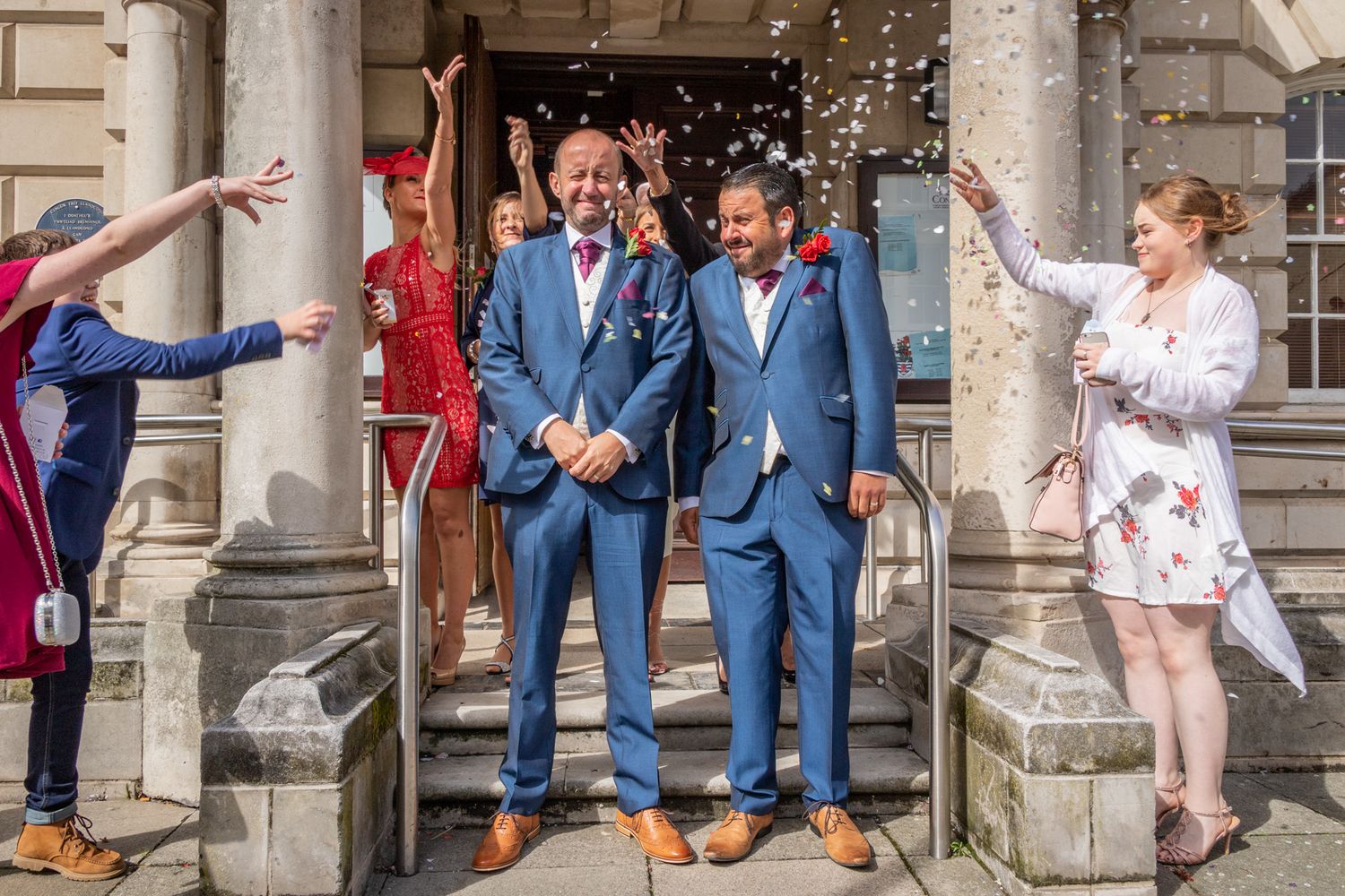2 grooms being showered with confetti after their wedding ceremony at Llandudno Town Hall. LGBTQ wedding photographer