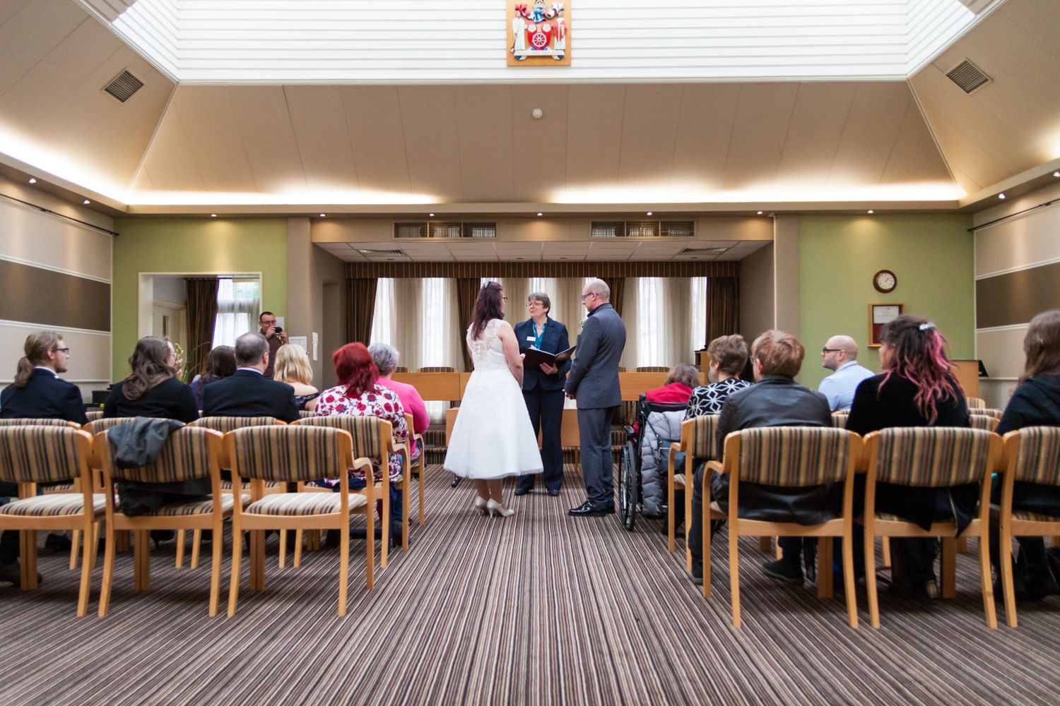 Looking down the aisle as a couple get married.