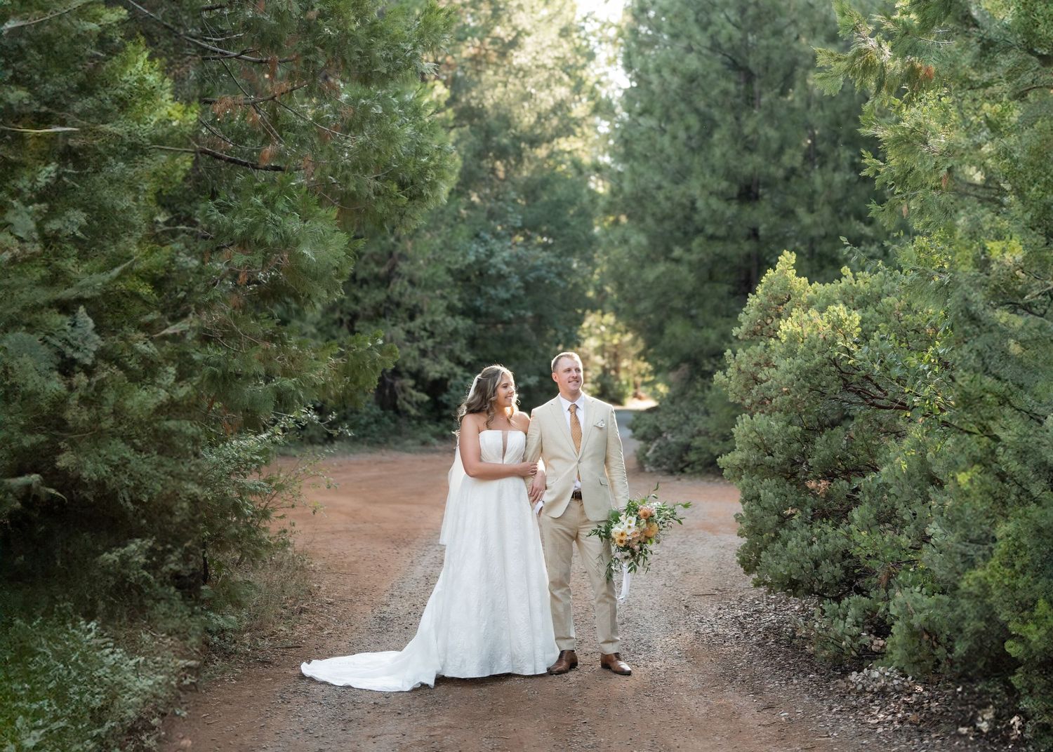 A bride and groom on their wedding day taking photos with their wedding photographer at a Northern California wedding venue.