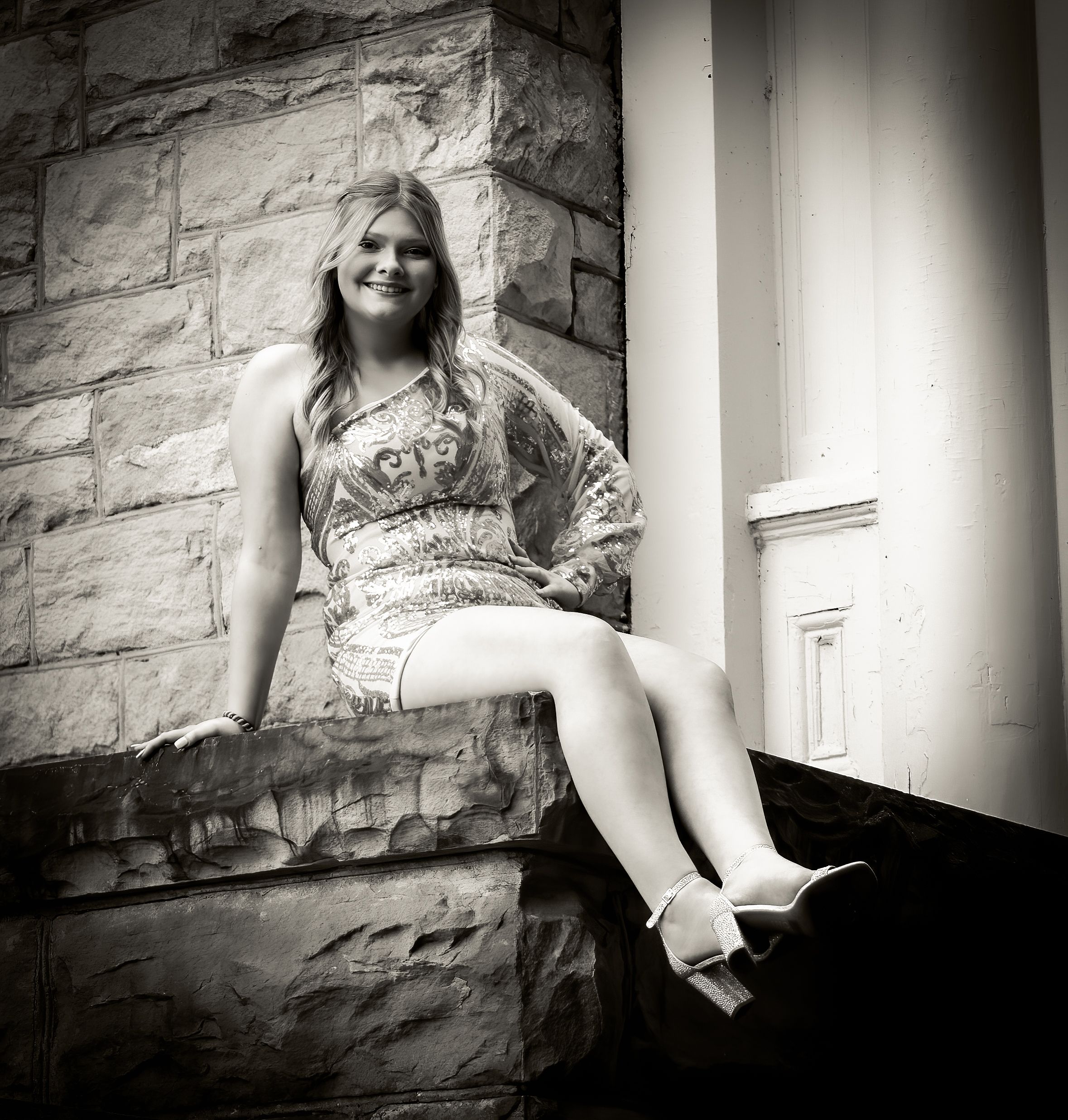Two people pose on brick pavers wearing sparkly dresses and holding bouquets at a formal event.
prom 
riverside