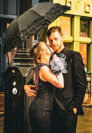 A couple shares an intimate moment under a lace umbrella in the snow.
prom 
riverside