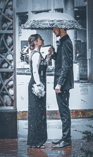 A delicate bouquet of pink roses and white baby's breath wrapped in purple ribbon.
prom 
riverside