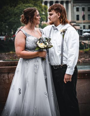A couple stands near a lamp post during their wedding photoshoot.
prom 
riverside