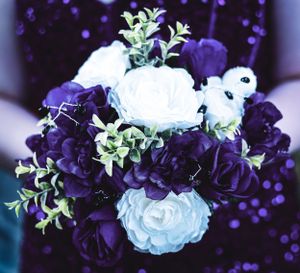 An elegant bouquet featuring white and deep purple flowers with green foliage against a dark background.
prom 
riverside