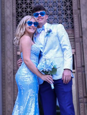 A couple wearing matching blue sunglasses and formal attire pose playfully for a prom or wedding photo.
prom 
riverside