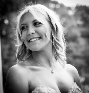 A close-up black and white portrait of someone wearing a strapless dress and delicate necklace.
prom 
riverside