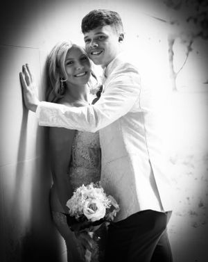 A couple shares an intimate black and white moment against a wall in formal attire.
prom 
riverside