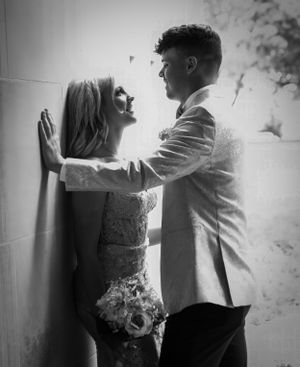A romantic black and white photo of a couple posing against a wall with a bouquet.
prom 
riverside