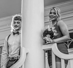 Black and white formal portrait of a couple posing by an elegant white column in formal attire.
prom 
riverside
