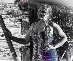 Artistic black and white photo with selective color of person in sparkly dress by rustic wall.
prom 
riverside