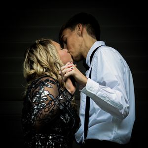 Intimate portrait of couple in formal wear sharing a romantic moment against dark background.
prom 
riverside