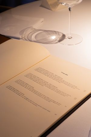 Open book pages with text and fish illustrations on a white surface.