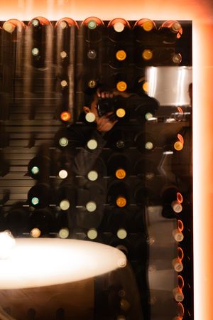 Blurred bokeh lights create an atmospheric effect against a dark background in a restaurant setting.