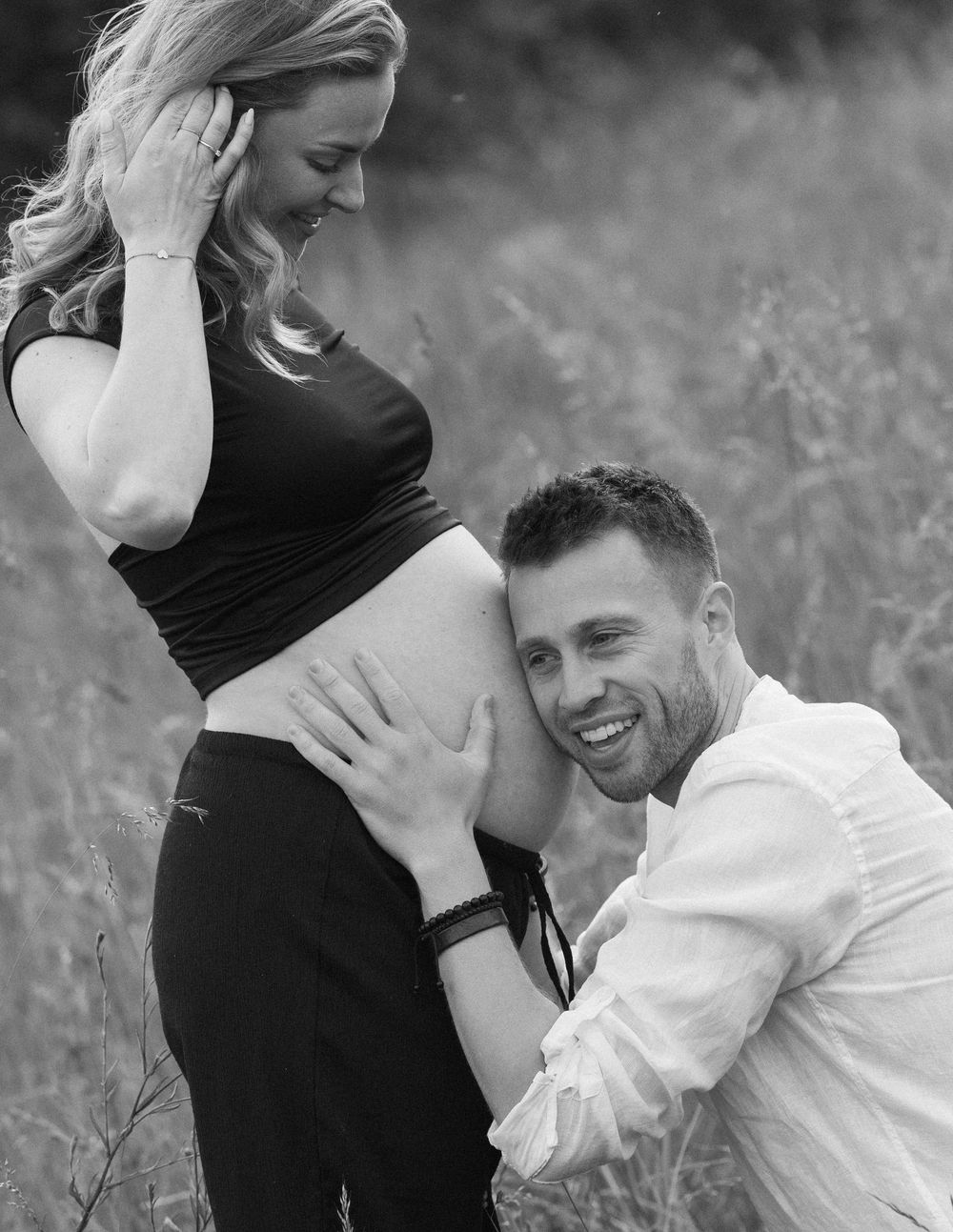 Candid moments captured between a couple during their maternity session in nature.