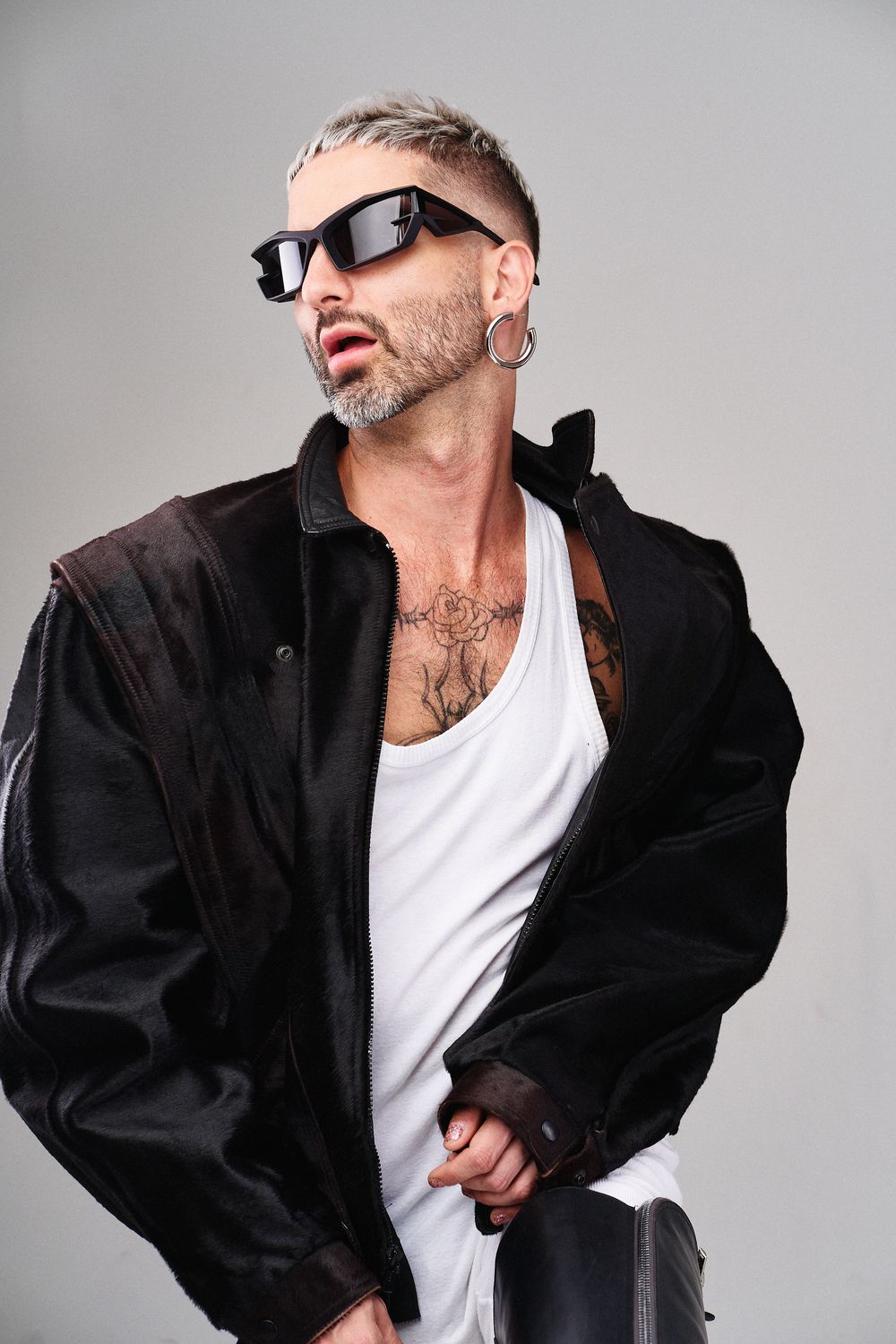Side view sequence of person in black jacket and white shirt posing dynamically against gray background.
