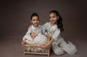 A series of six professional studio photographs showing tender family moments and newborn portraits in warm, neutral tones.