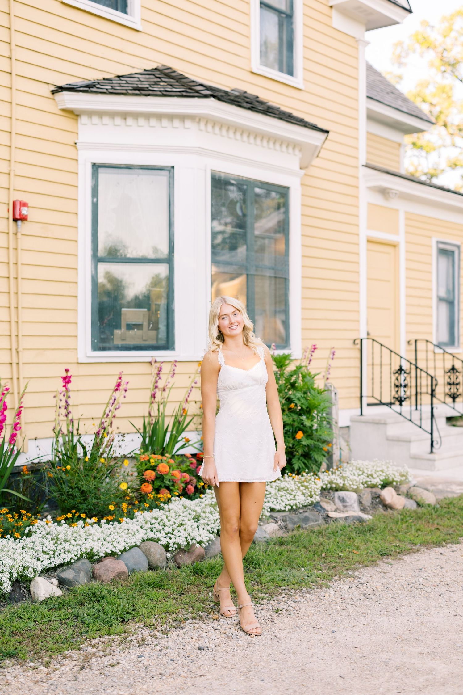 A sequence of photos against a yellow house with white trim and floral landscaping along a gravel path.