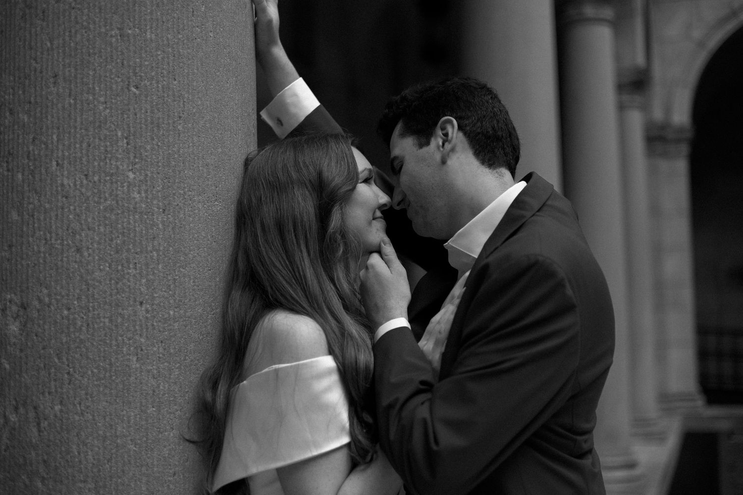 A romantic black and white photo collage showing a couple embracing and kissing in formal attire.