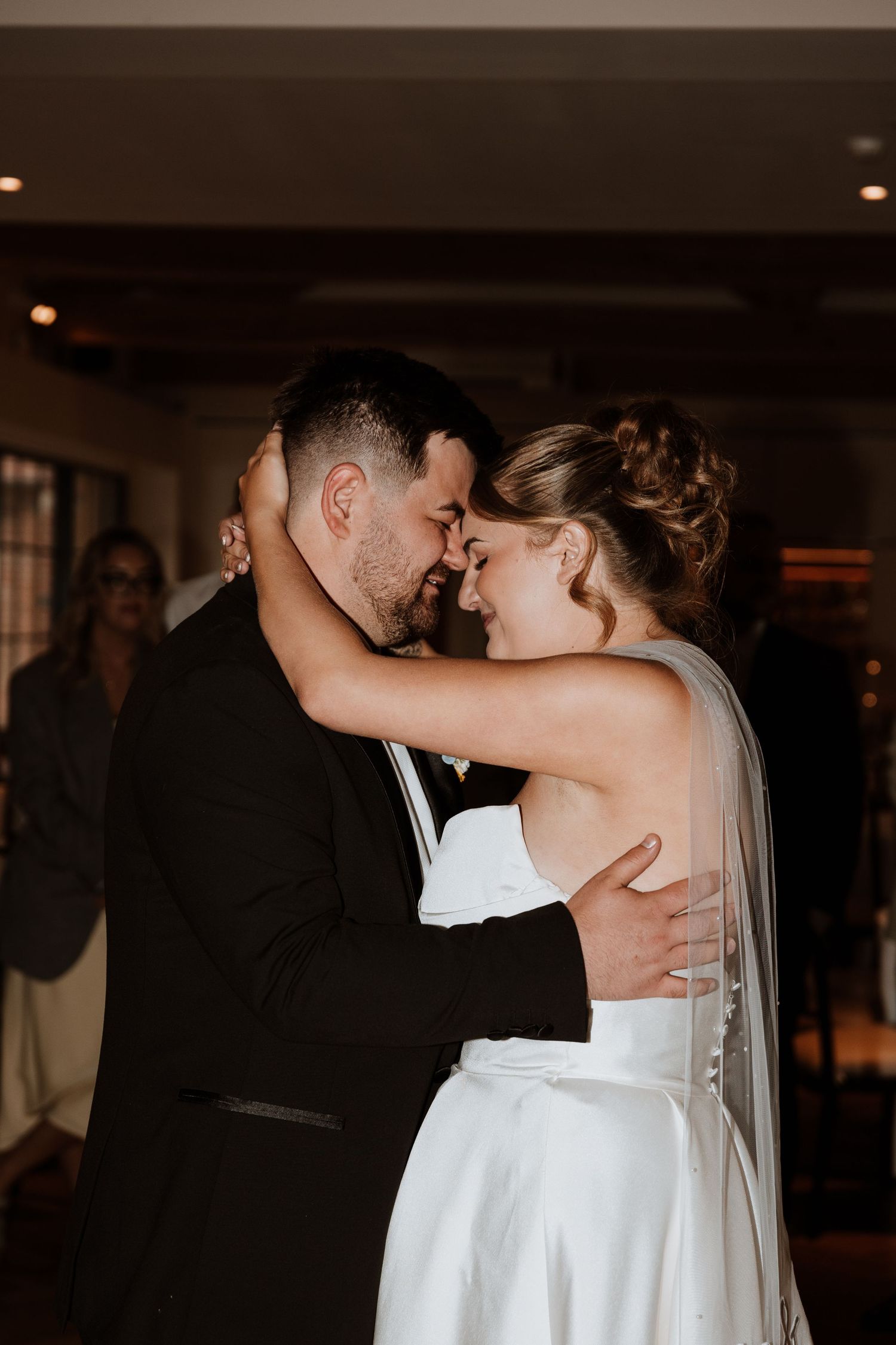 Romantic newlywed couple shares an intimate first dance moment at their wedding reception at Chester Zoo