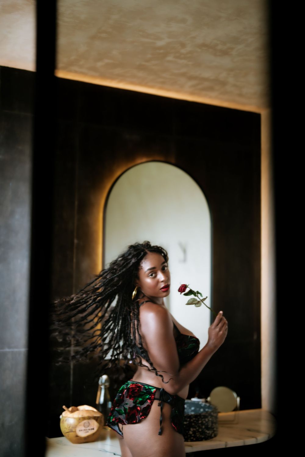 Artistic portraits through arched windows creating dramatic shadows and lighting effects.