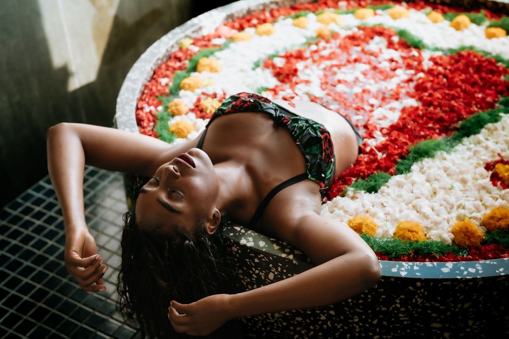 Intimate portrait surrounded by vibrant red and white flower petals.