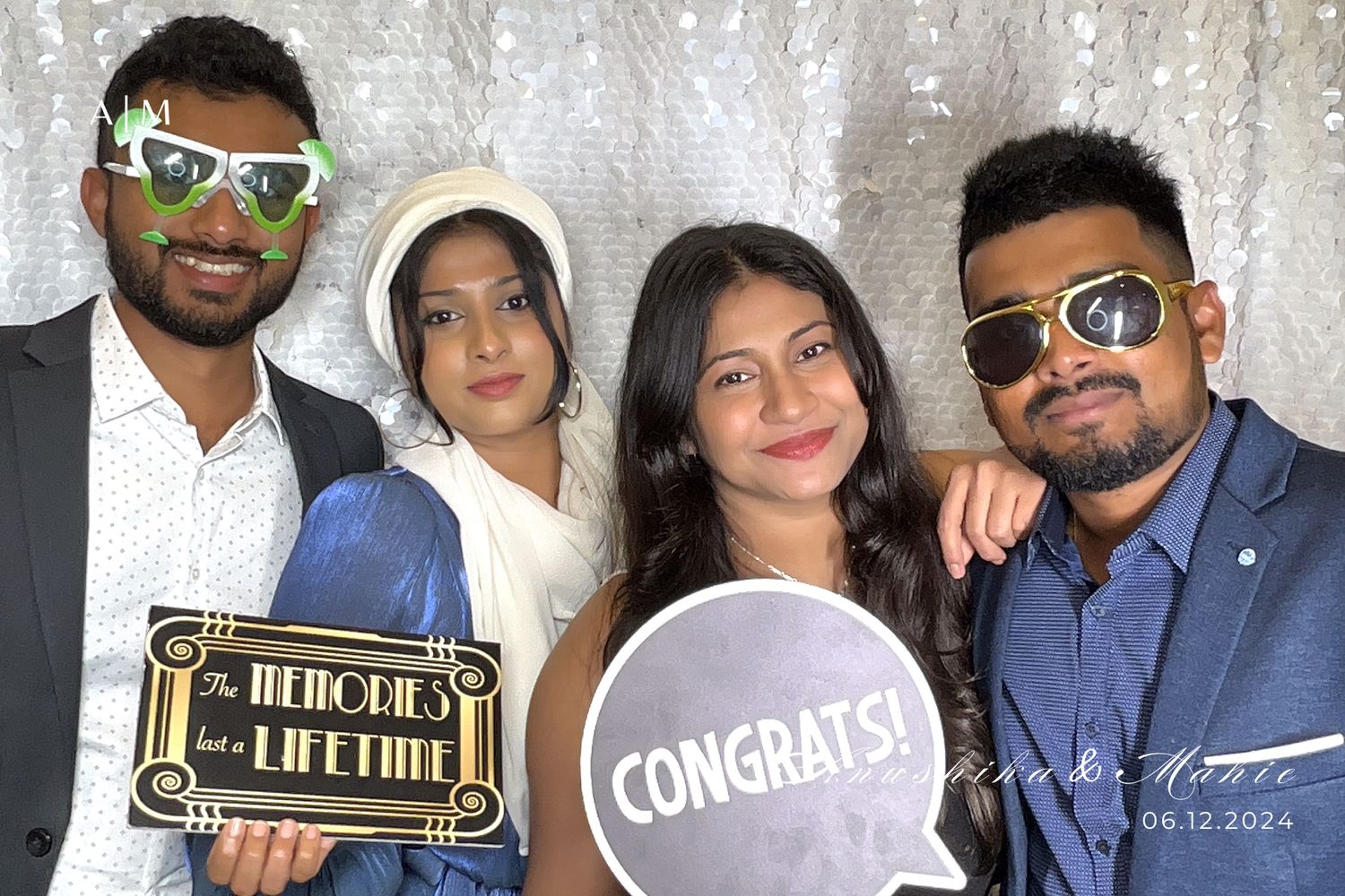 A group of people posing together at what appears to be a celebration or social gathering with decorative elements.