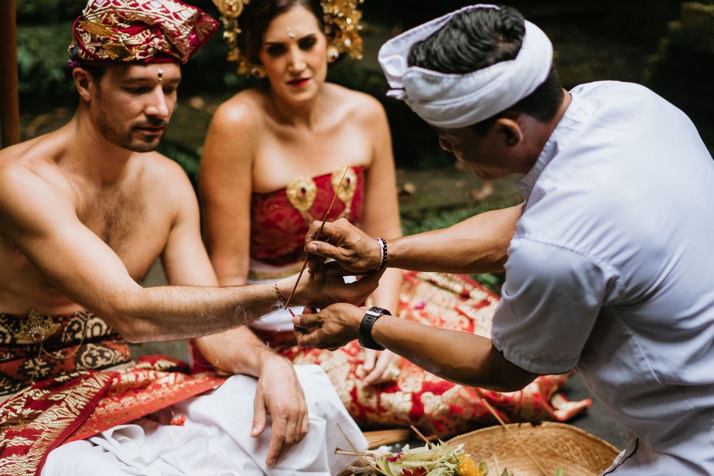 Wedding ceremony preparations with traditional Balinese offerings and rituals.