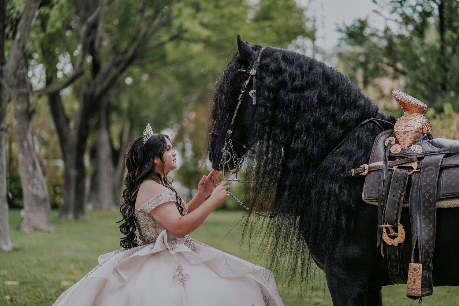 A couple shares an intimate moment in a wooded outdoor setting during a rainy photo session.