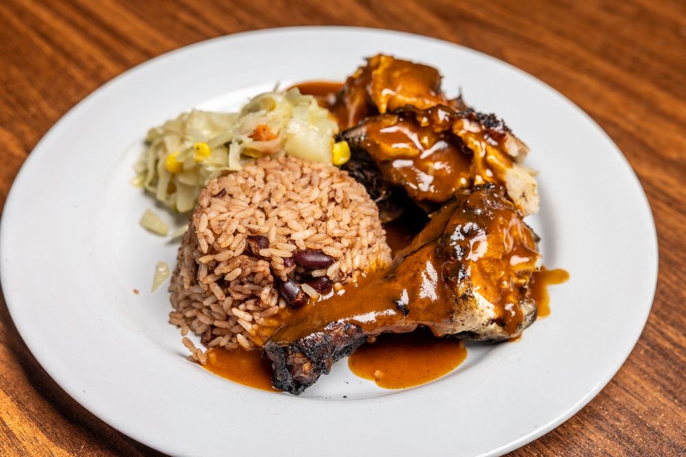 Chocolate covered bread pudding served on white plates with caramel sauce drizzled on top.
