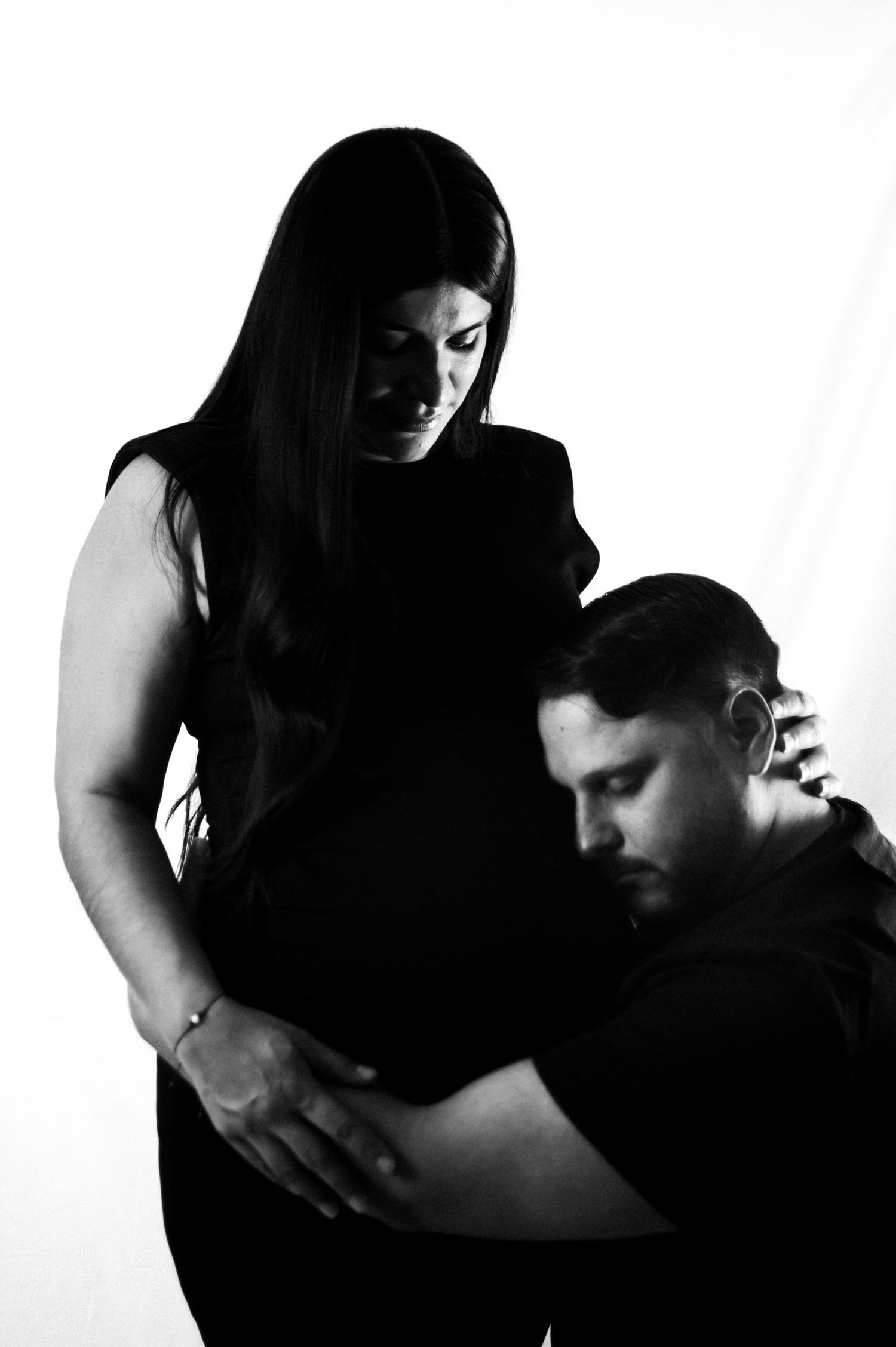 High contrast black and white artistic photo series showing intimate couple in embracing poses.