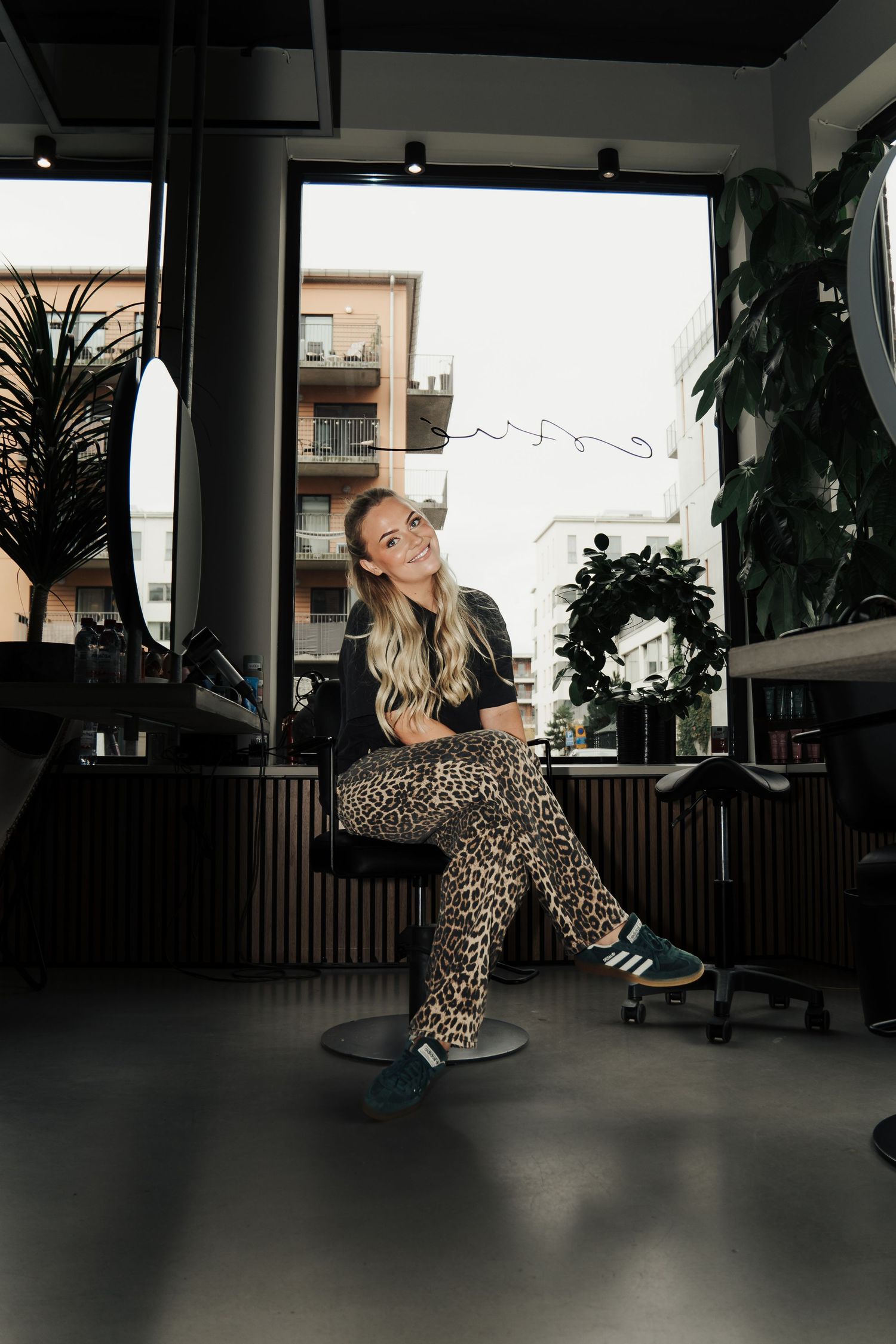Fashion shoot sequence in dark office setting featuring leopard print outfit.