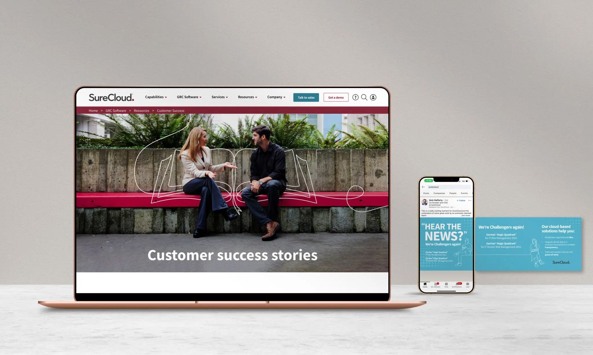 SureCloud customer success stories displayed on laptop and mobile devices with teal branded marketing materials.