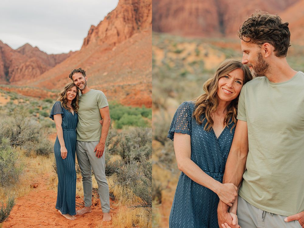 Couple posing together in red rock desert landscape, wearing coordinating blue and green outfits.