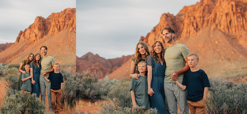 Family of five posing together in front of stunning red rock cliffs in a desert setting.