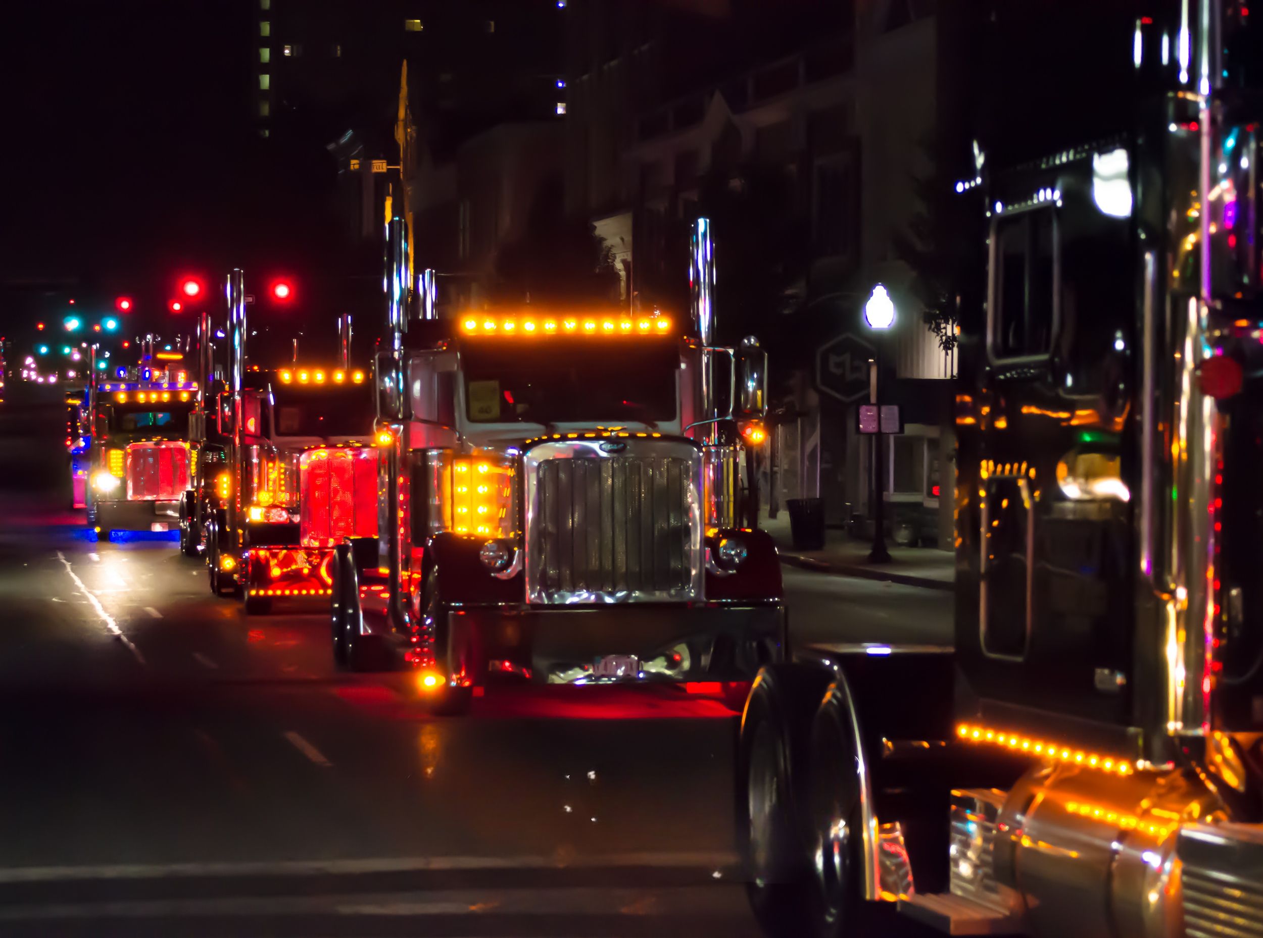 Custom show truck convoy with LED lights rolling through downtown at night Joplin, Missouri
