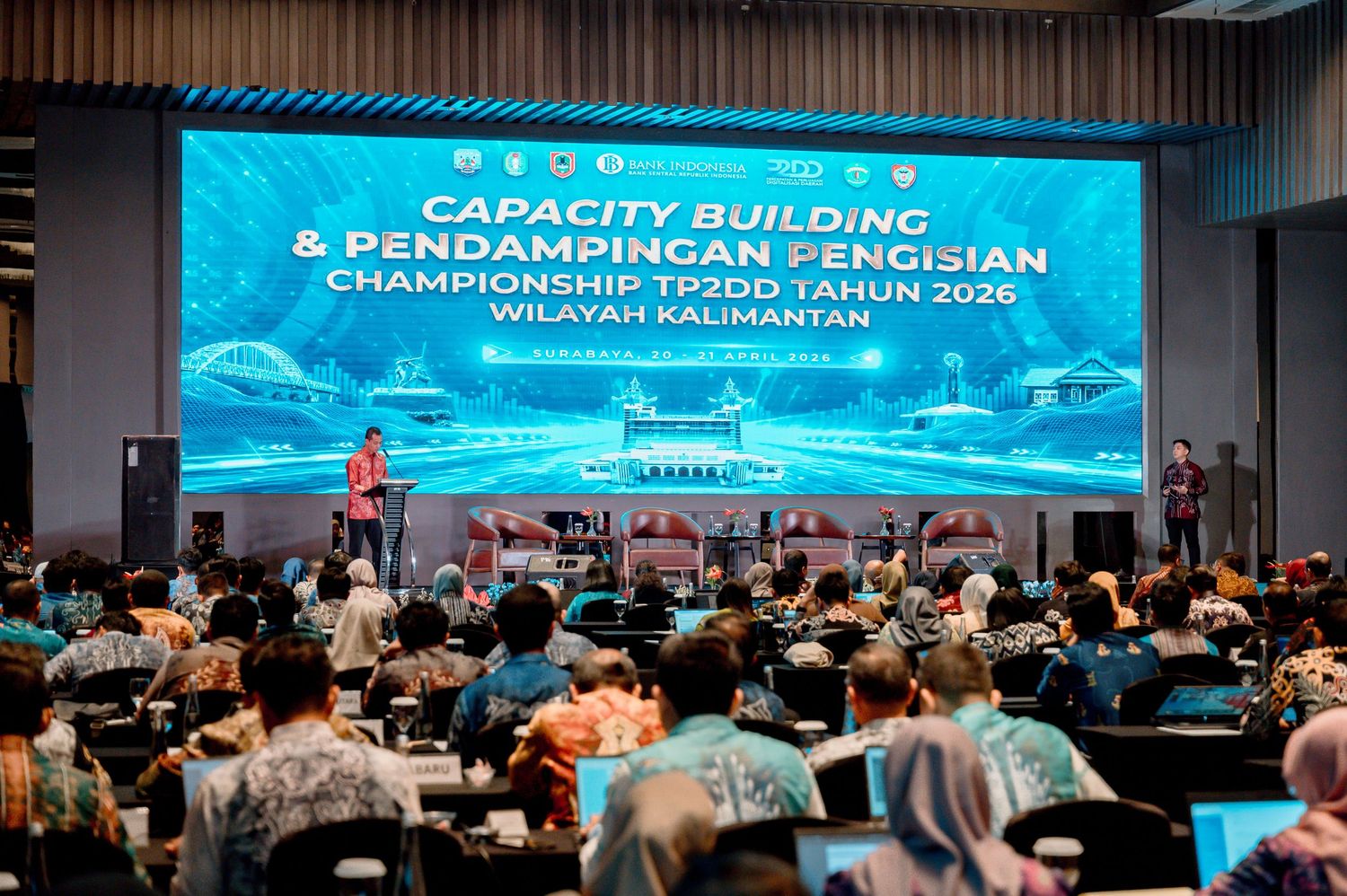 Capacity Building event in Kalimantan region, TP2DD Championship 2026, large conference hall with attendees and stage presentation.